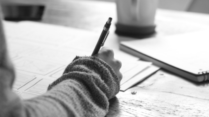 Black and white image of a woman writing