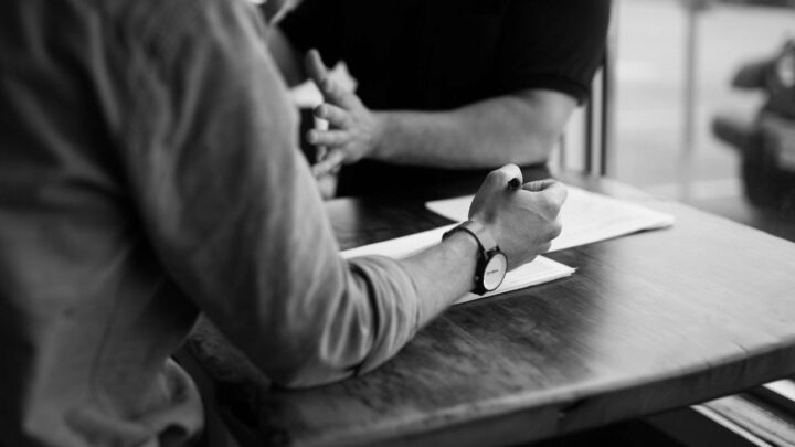 Two people at a desk discussing ideas article feature